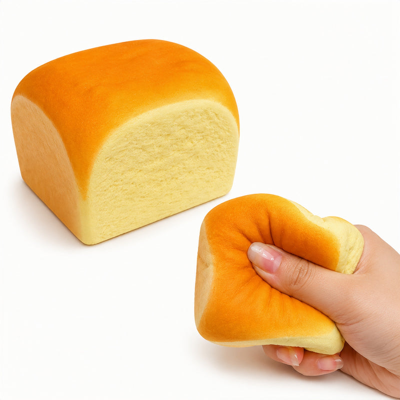 Loaf of bread and a hand holding a piece of bread on a white background