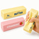 Two wax bars, one labeled 'Salted Butter' and the other 'Strawberry', with a hand holding a yellow 'Butter' bar.