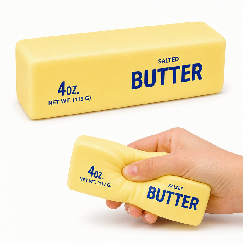 Yellow block of salted butter with blue text, held by a hand on a white background