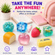 Colorful office supplies including a pink backpack, notebooks, and stress relievers on a light background.