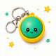 Keychain with a green round face and yellow border on a white background with stars.