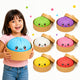 Child holding a set of colorful bun-shaped toys with smiling faces on a white background.