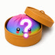 Colorful ball with a question mark and smiley face in an open tan box on a white background