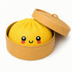 Yellow bento box with a face design on a white background