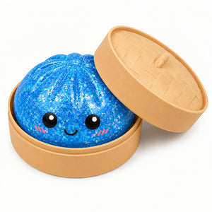 Blue glittery ball with a smiling face in a tan container on a white background