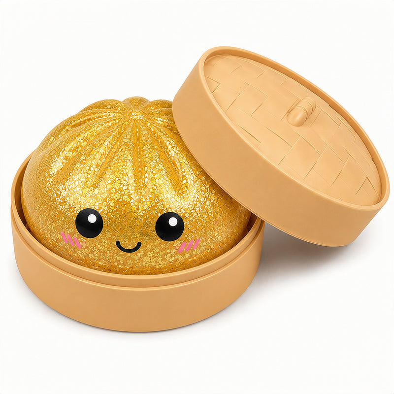 Gold glittery bun with a smiling face in a tan container on a white background