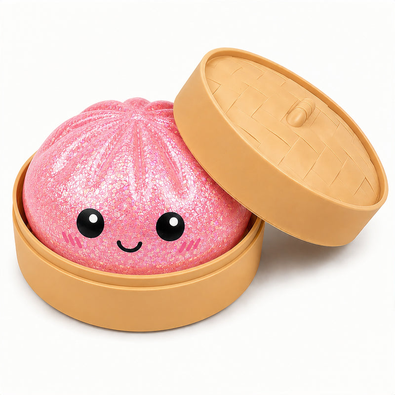 Pink glittery bath bomb with a smiling face in a tan container on a white background