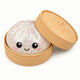 Sparkly ball with a smiley face in a tan container on a white background