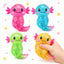 Four colorful axolotl-shaped toys with a hand holding one, on a white background.