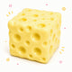 Cube-shaped cheese with holes on a white background