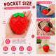 Red strawberry-shaped stress reliever with green leaves, held in a hand and shown in various settings.